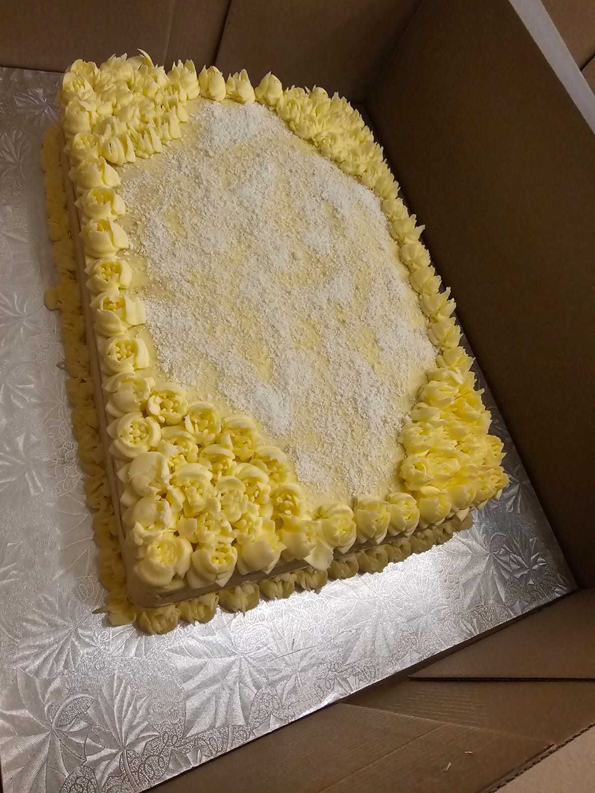 Coconut slab cake piped with buttercream flowers