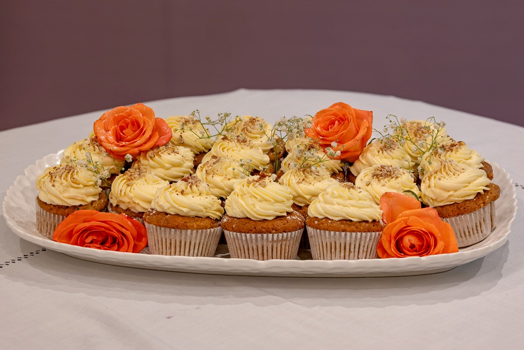 Carrot cupcakes piped with cream cheese frosting