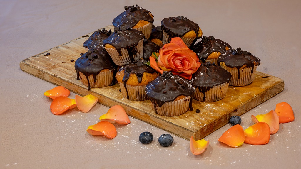 Chocolate-dipped muffins on a board