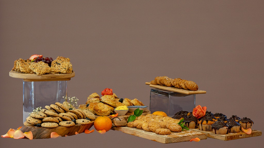 A long spread of cookies, muffins, scones, crunchies and health bars
